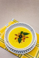 Corn cream soup with fresh vegetables, herbs and spices