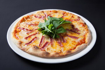 Ham and cheese pizza rocket leaves on it