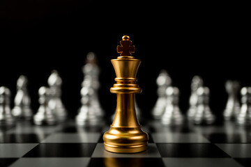 Golden King chess standing in front of other chess, Concept of a leader must have courage and...