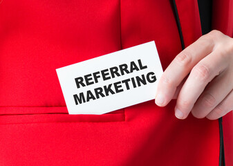 Businessman showing card with text Referral Marketing