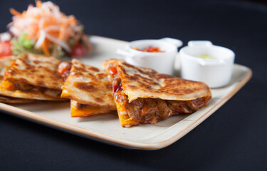 Quesadilla wish salad and sauces horizontal view close up