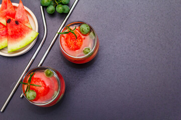Fresh non-alcoholic fruit cocktail with juicy watermelon, green grape, rosemary and tonic water