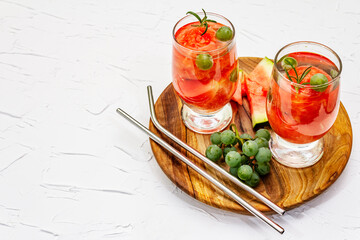 Fresh non-alcoholic fruit cocktail with juicy watermelon, green grape, rosemary and tonic water