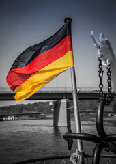 German national flag waving at the stern of a ship on the River Elbe
