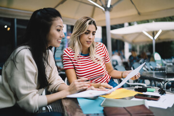 Diverse remote colleagues have brainstorming meeting for analyzing documents during paperwork in...