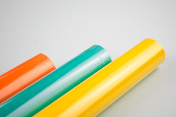 
Multi-colored paper in rolls, on a white background.