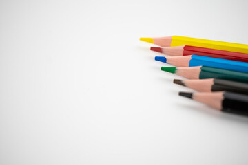 Colored pencils on a white background. Flat lay.
Copyspace.