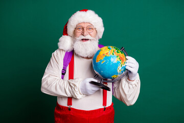 Portrait of his he nice handsome cheerful smart clever bearded fat Santa learner holding in hands globe country continent ecology lesson map planet science knowledge isolated green color background