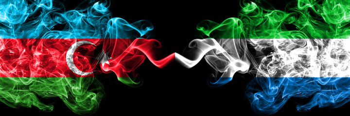 Azerbaijan, Azerbaijani vs Sierra Leone smoky mystic flags placed side by side. Thick colored silky abstract smoke flags