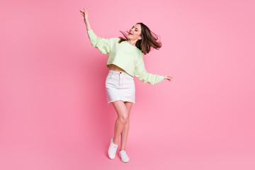 Full length photo of attractive lady excited dance disco hit youth party hairdo flight wear casual green crop pullover naked belly jeans short skirt shoes isolated pink color background