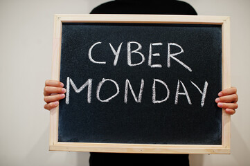 Cyber monday written on blackboard. Black friday concept. Boy hold board.