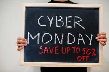 Cyber monday save up to 50% off written on blackboard. Black friday concept. Boy hold board.