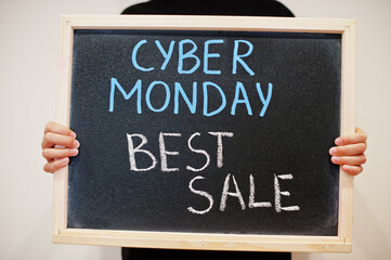 Cyber monday best sale written on blackboard. Black friday concept. Boy hold board.