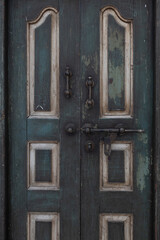 close up view of ancient wooden door with rusty old slide or tower bolt