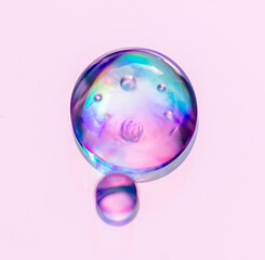 Blue drops of water on a pink background.