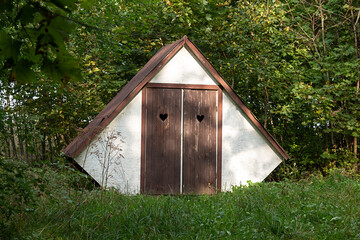 Old outdoor toilet in the park. Dry toilet in nature