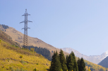 Power line tower high in the mountains in autumn.