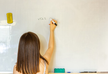 young woman writing on whiteboard