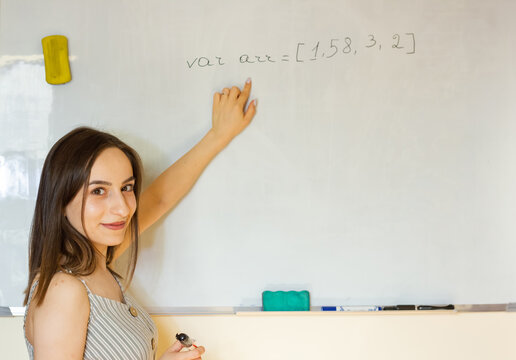 young woman writing on whiteboard