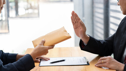 Confident businessman manager rejecting an offer of money to agreement contract from partner or...