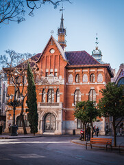 old town hall. square behind the house and bench and trees