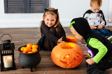 Fototapeta premium Kids in carnival costumes are celebrating Halloween
