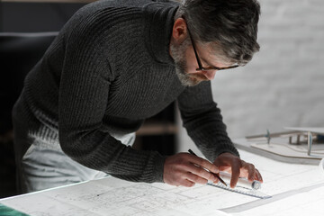 Architect drawing blueprints in office. Engineer sketching a construction project. Architectural...