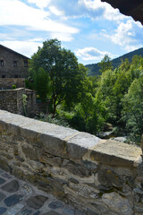 Fototapeta na wymiar BEGET, CATALONIA, SPAIN, EUROPE, SEPTEMBER 2020. Beautiful view from the Roman bridge of the picturesque medieval town of Beget, it is an important tourist place in Catalonia.