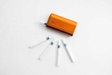 Heat-not-burn product with  sticks on white background. Alternative smoking concept.