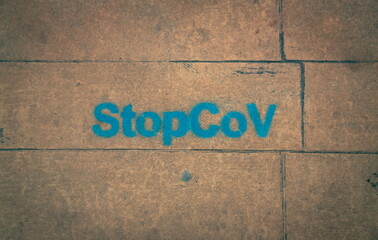 StopCov sign painted on the ground