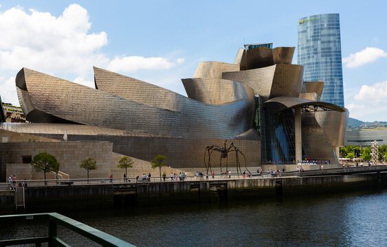 BILBAO, SPAIN - JULY 16, 2019: View Of Building Of Guggenheim Museum With Sculpture Of Spider On Bank Of Nervion River..