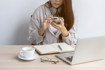 A business woman using a cell phone in her office.