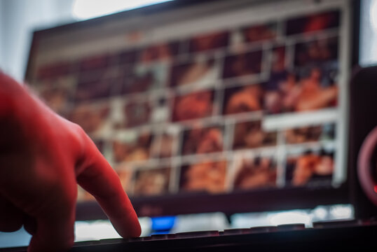 user's hand searches the Internet for an illegal site, horizontal frame,