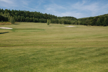 Golf course in cuntryside. Sun set in summer evening
