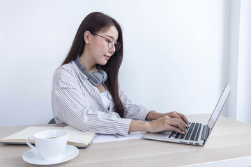 Close up photo of a woman typing on a laptop.