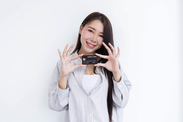 A beautiful woman standing with a credit card For online shopping.