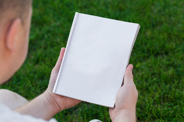 Layout of the cover of the magazine, catalog, book. a man reading a blank magazine, catalog, book...