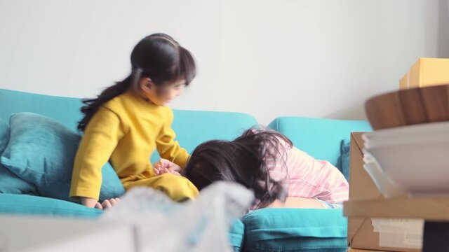 happiness asian child sibling girlfriend playing fun together casual cloth relax leisure weekend activity on sofa couch home