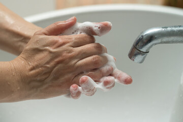 Prevent coronavirus or COVID-19 concept. Handwashing of cleaning hand wash with bubble liquid soap ...