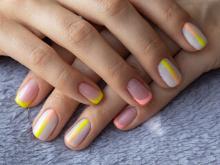 Nice women's manicure, a combination of three colors, pink, yellow and white