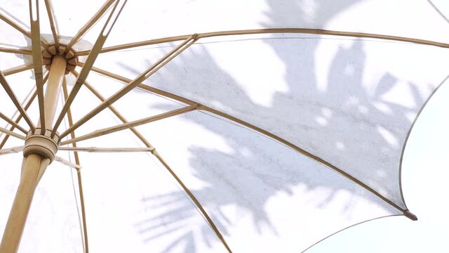 Handmade white cotton Asian garden umbrella made of bamboo wood in Thailand