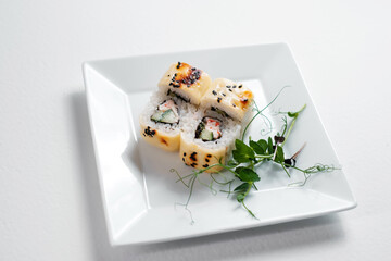 Rainbow sushi roll, uramaki, hosomaki and nigiri. Japanese oriental cuisine. Sushi rolls with avocado.