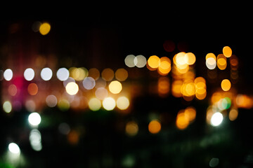 yellow orange and white bokeh on black background. Lights out of focus