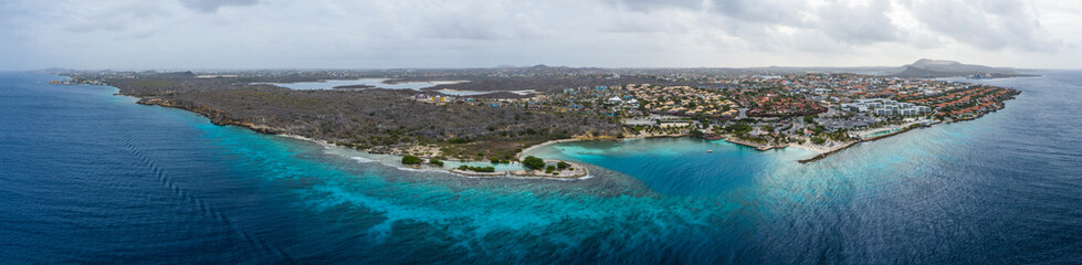 Aerial view of coast of Curaçao in the Caribbean Sea with turquoise water, cliff, beach and beautiful coral reef