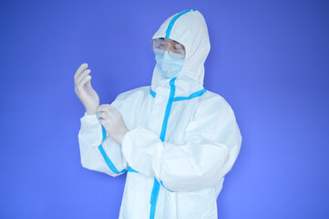 Fototapeta premium An Asian man is wearing ppe suit on purple background