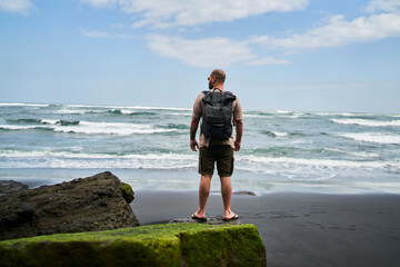 Anonymous man enjoying freedom on beach