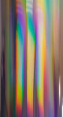 high res full frame macro photo of round abstract pastel iridescent holographic foil background with light leaks. holo color wrinkled material. cool glitter surface with shiny rainbow feel.