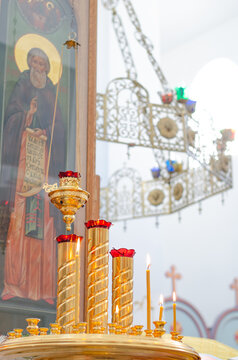 Interior of a Christian Orthodox Church in Russia. Candles, icons, and flowers. The religious concept.