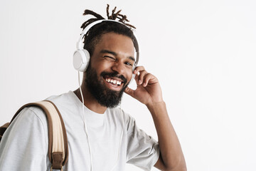 Photo of guy winking while listening music with headphones