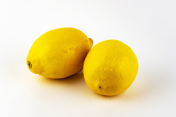 Two lemons on a white background.